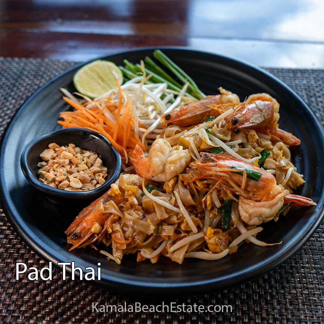 Authentic Pad Thai served at Kamala Beach Estate — rice noodles with shrimp, bean sprouts, crushed peanuts, and lime.