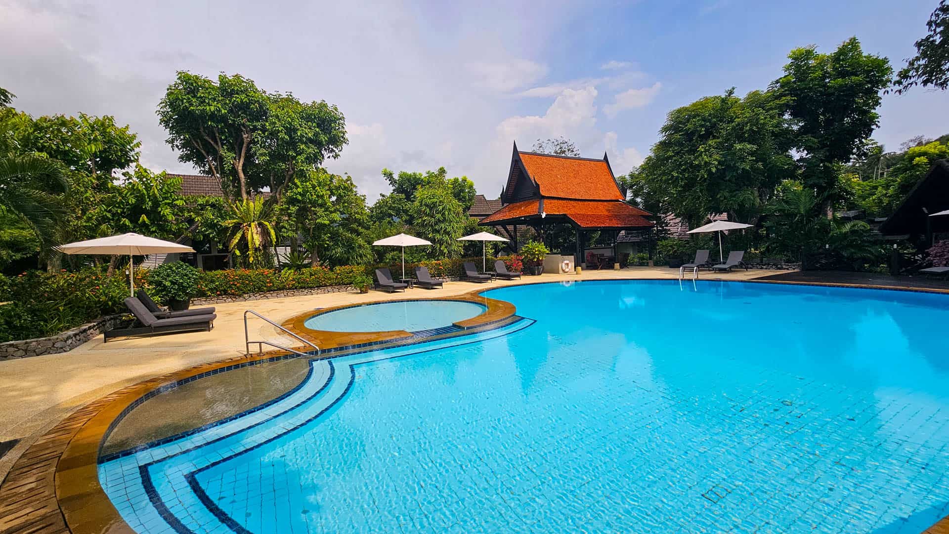 The main swimming pool and adjoining children's pool, with a Thai pavilion and tropical gardens